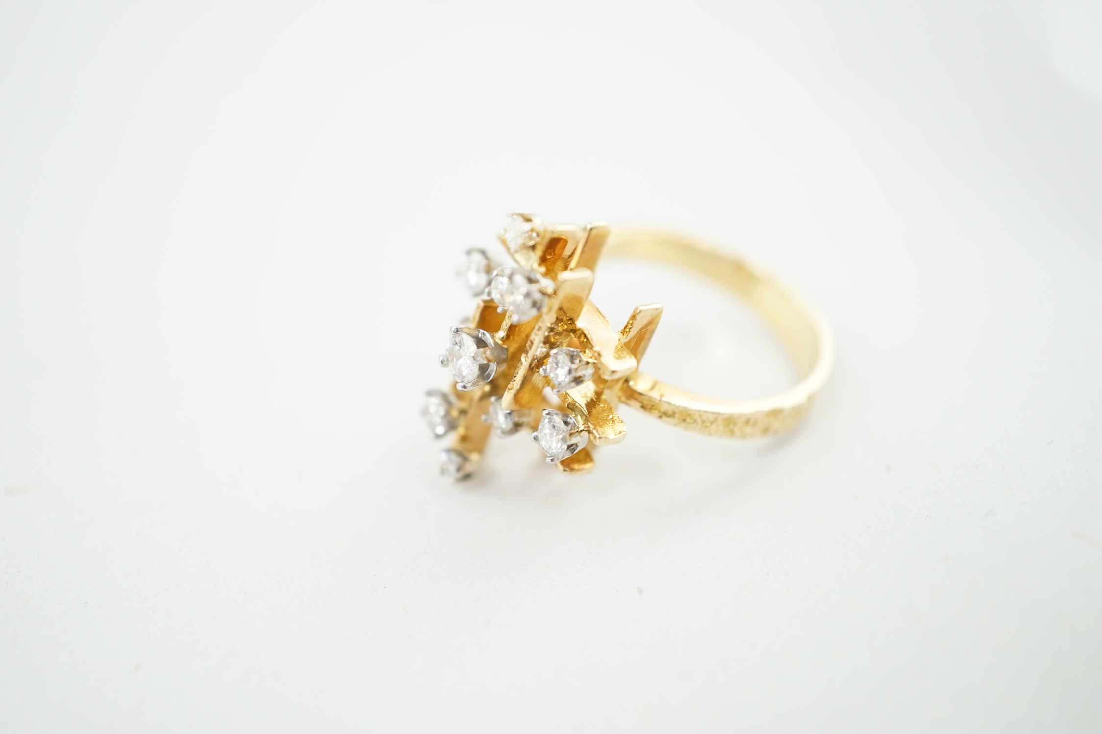 A 1970's 18ct gold and graduated diamond cluster set modernist ring